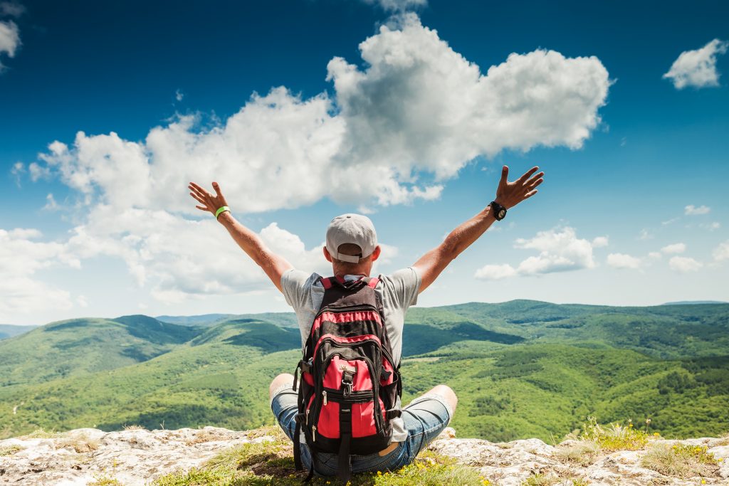 Man Hiker Greeting Rich Nature On The Top Of Mountain